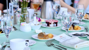 Tea Time Table set for Tea. Desserts, breads , and jelly.